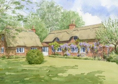 Thatched cottage with wisteria
